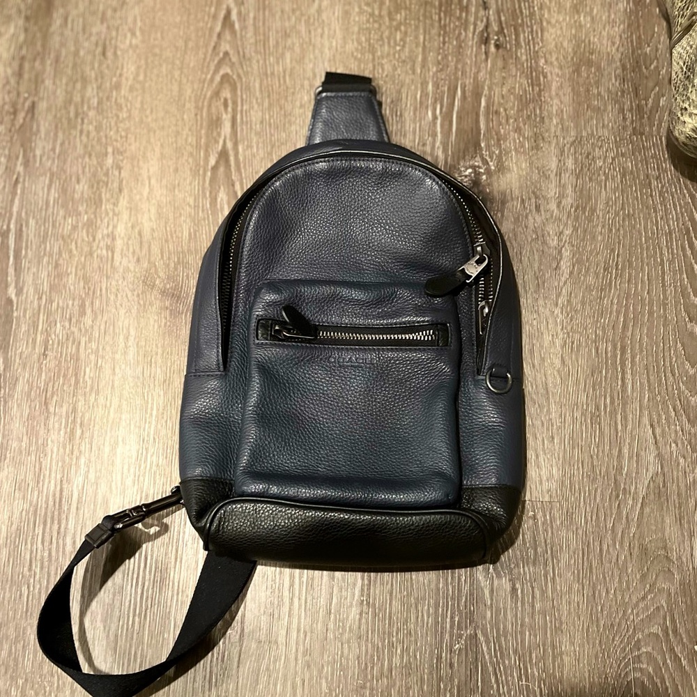 COACH one shoulder sling backpack.